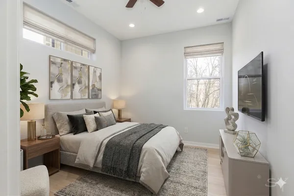 a bedroom with a bed and a flat screen tv