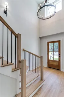 a view of a room with wooden floor and staircase