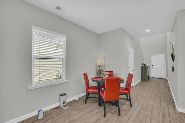 a kitchen with a sink and chairs