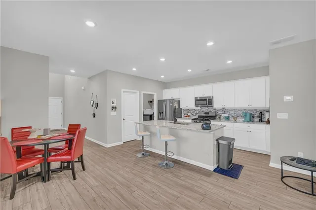 a large kitchen with a table and chairs