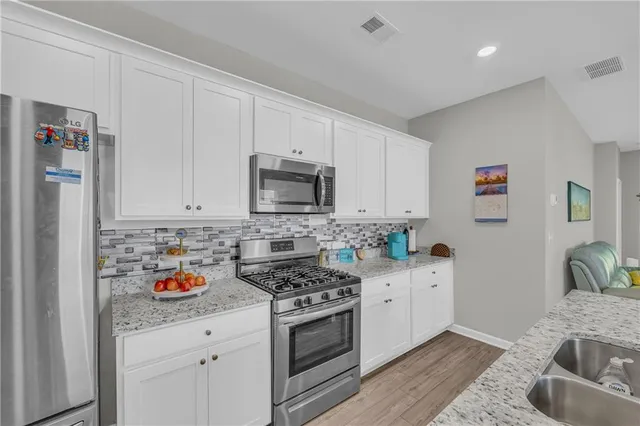 a kitchen with granite countertop living room and living room