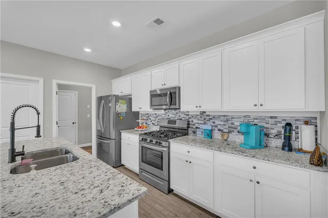 a view of a kitchen island wooden floor and windows