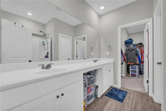 a spacious bathroom with a sink a mirror and a bathtub