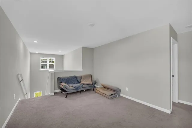 a view of a backyard with table and chairs potted plants and wooden fence