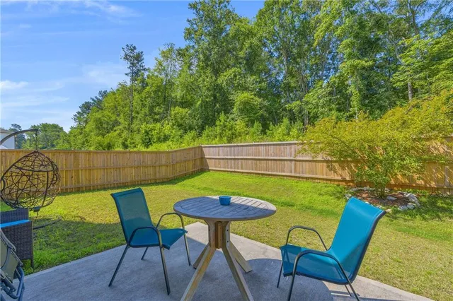 a view of a wooden house with a yard