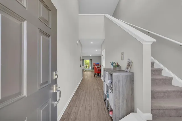 a view of a hallway with wooden floor and staircase