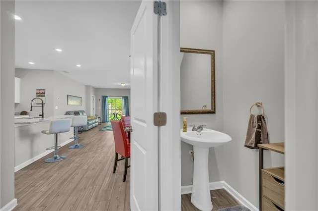 a bathroom with a sink toilet and a mirror