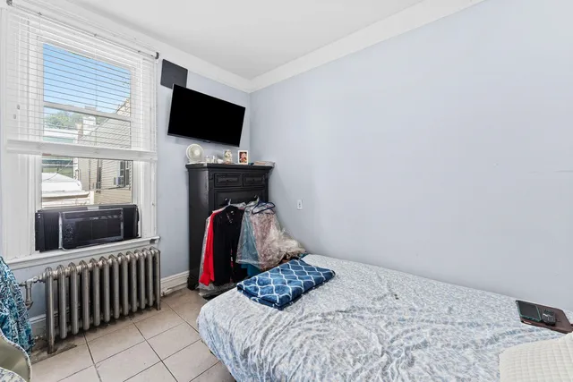 a bedroom with a bed and flat screen tv