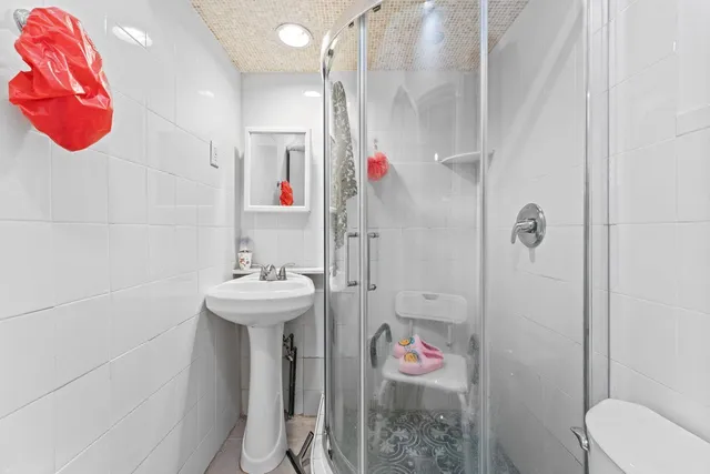 a bathroom with a sink toilet and shower