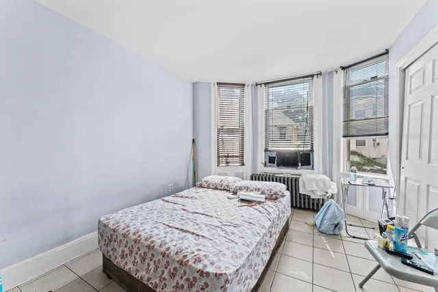 a bedroom with a bed and glass window