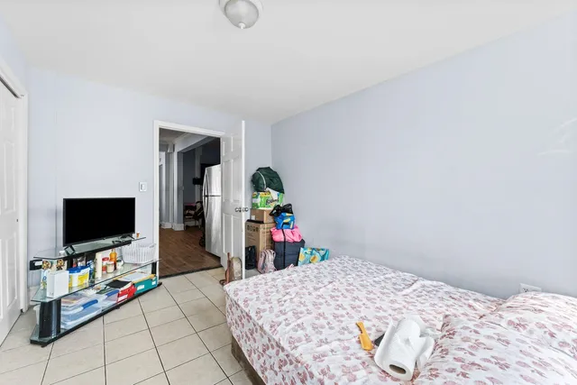 a bedroom with bed and flat screen tv