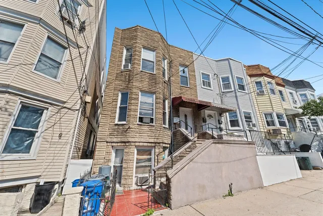 a front view of a residential apartment building with a yard