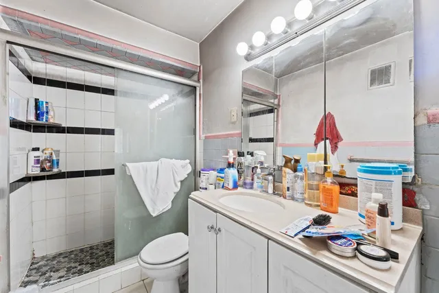 a bathroom with a sink vanity mirror and toilet