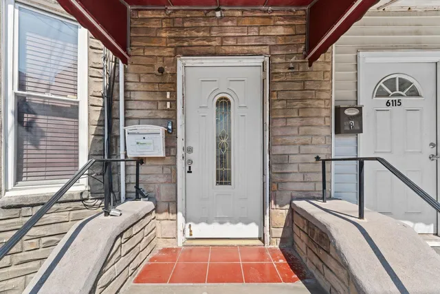 a front view of a house with large windows