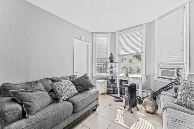 a living room with furniture and large windows