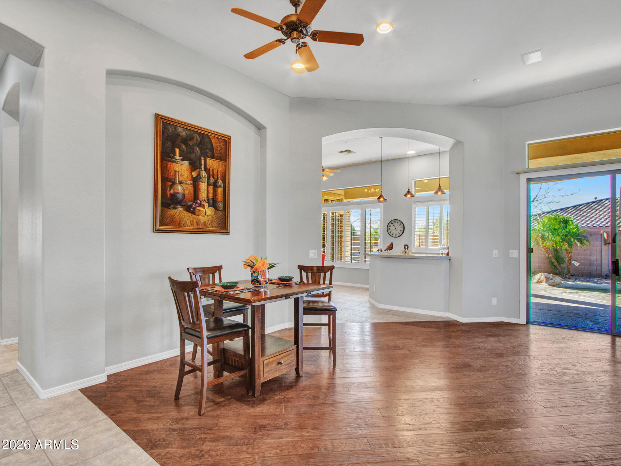 42047 North Moss Springs Road Anthem, AZ 85086 - Photo 14 of 72 a view of a dining room with furniture and a wooden floor
