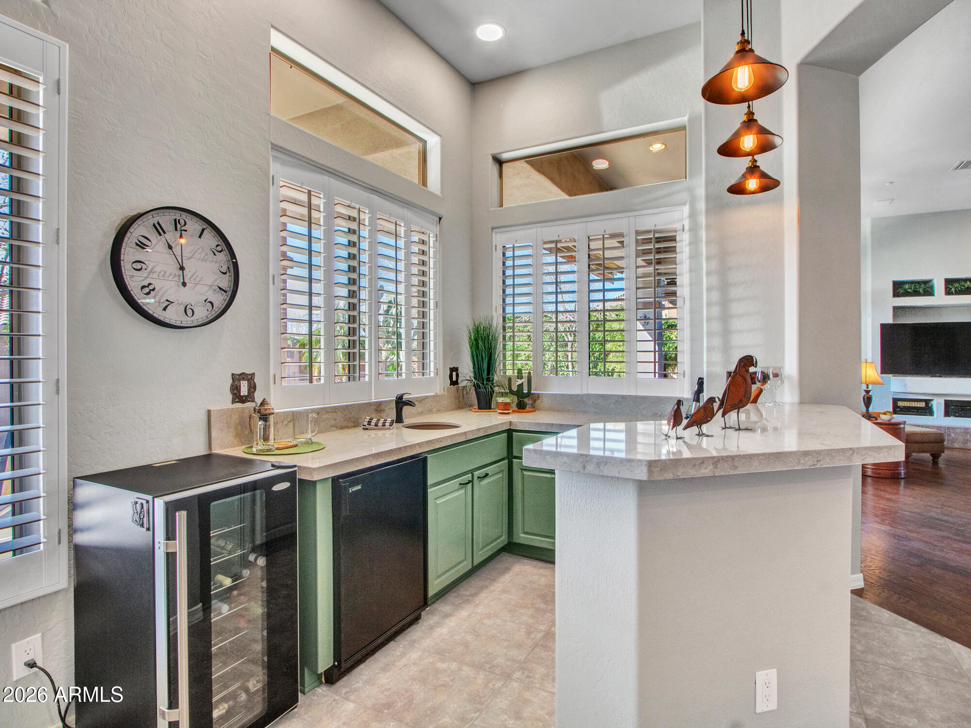 42047 North Moss Springs Road Anthem, AZ 85086 - Photo 17 of 72 a kitchen with stainless steel appliances granite countertop a sink and a large window