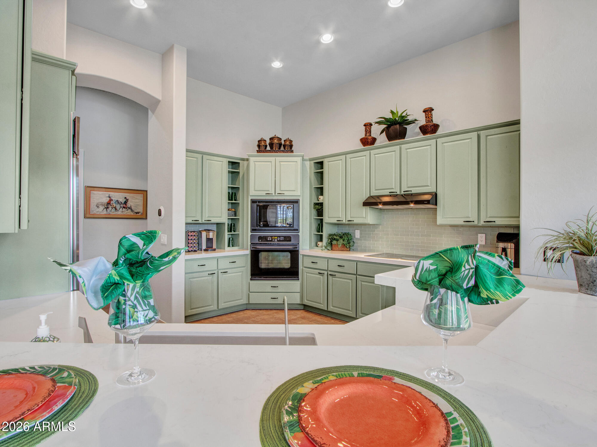 42047 North Moss Springs Road Anthem, AZ 85086 - Photo 20 of 72 a kitchen with stainless steel appliances kitchen island granite countertop cabinets and living room