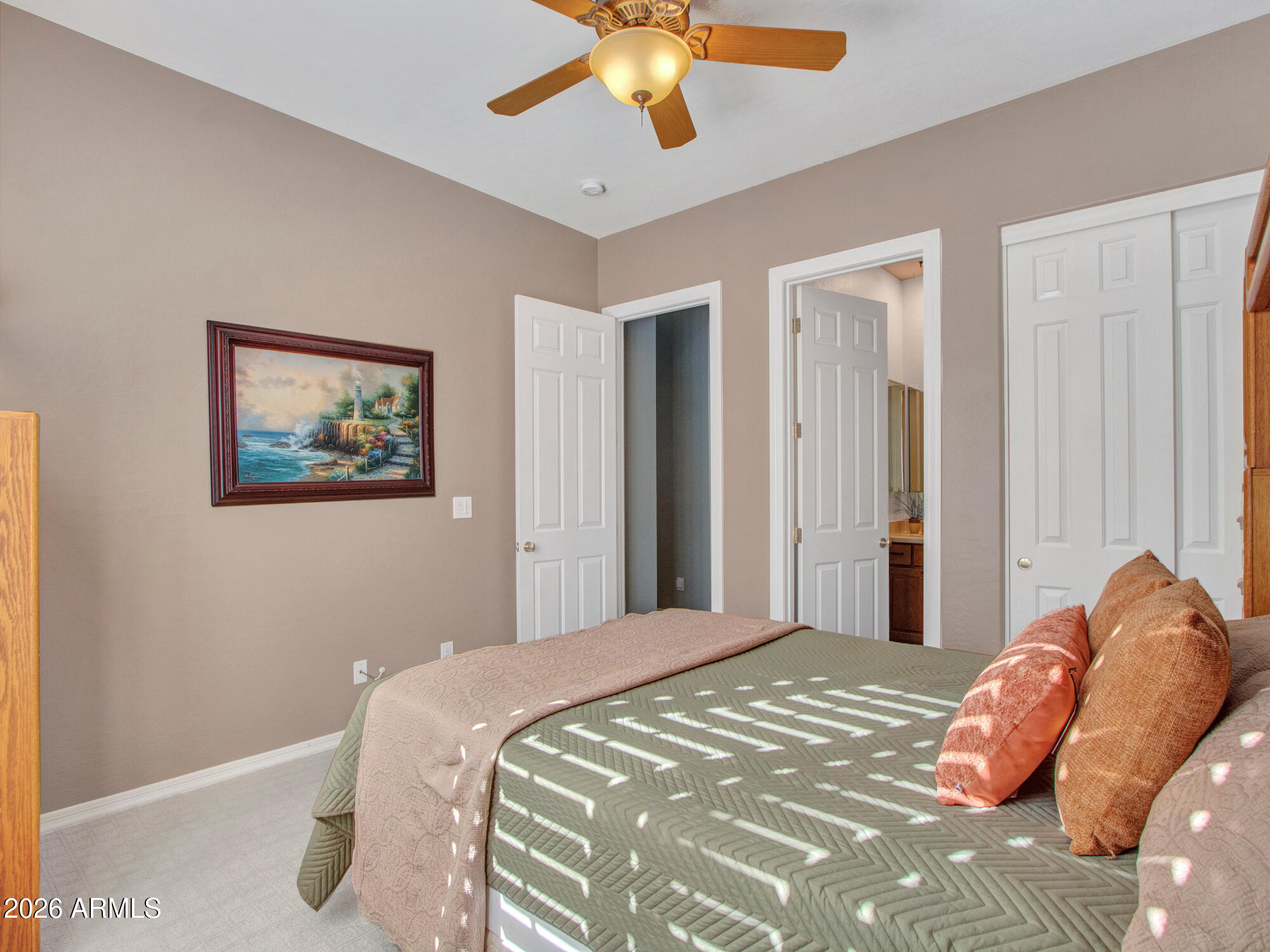 42047 North Moss Springs Road Anthem, AZ 85086 - Photo 30 of 72 a bedroom with a large bed and a chandelier