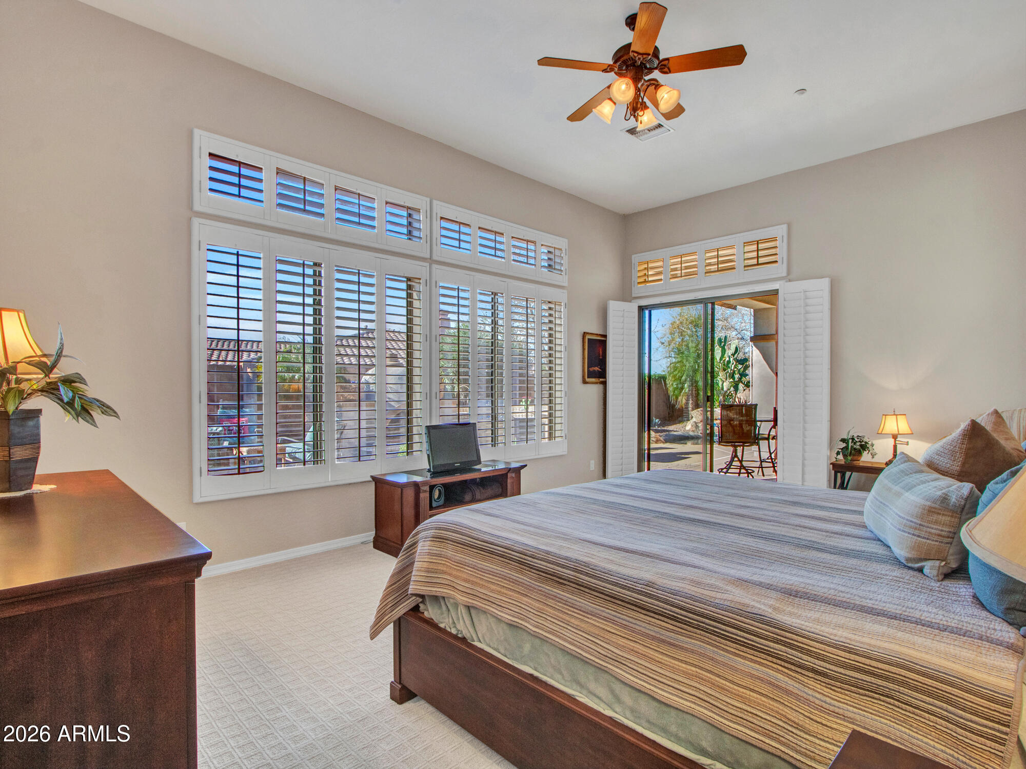 42047 North Moss Springs Road Anthem, AZ 85086 - Photo 33 of 72 a bedroom with a bed and large windows