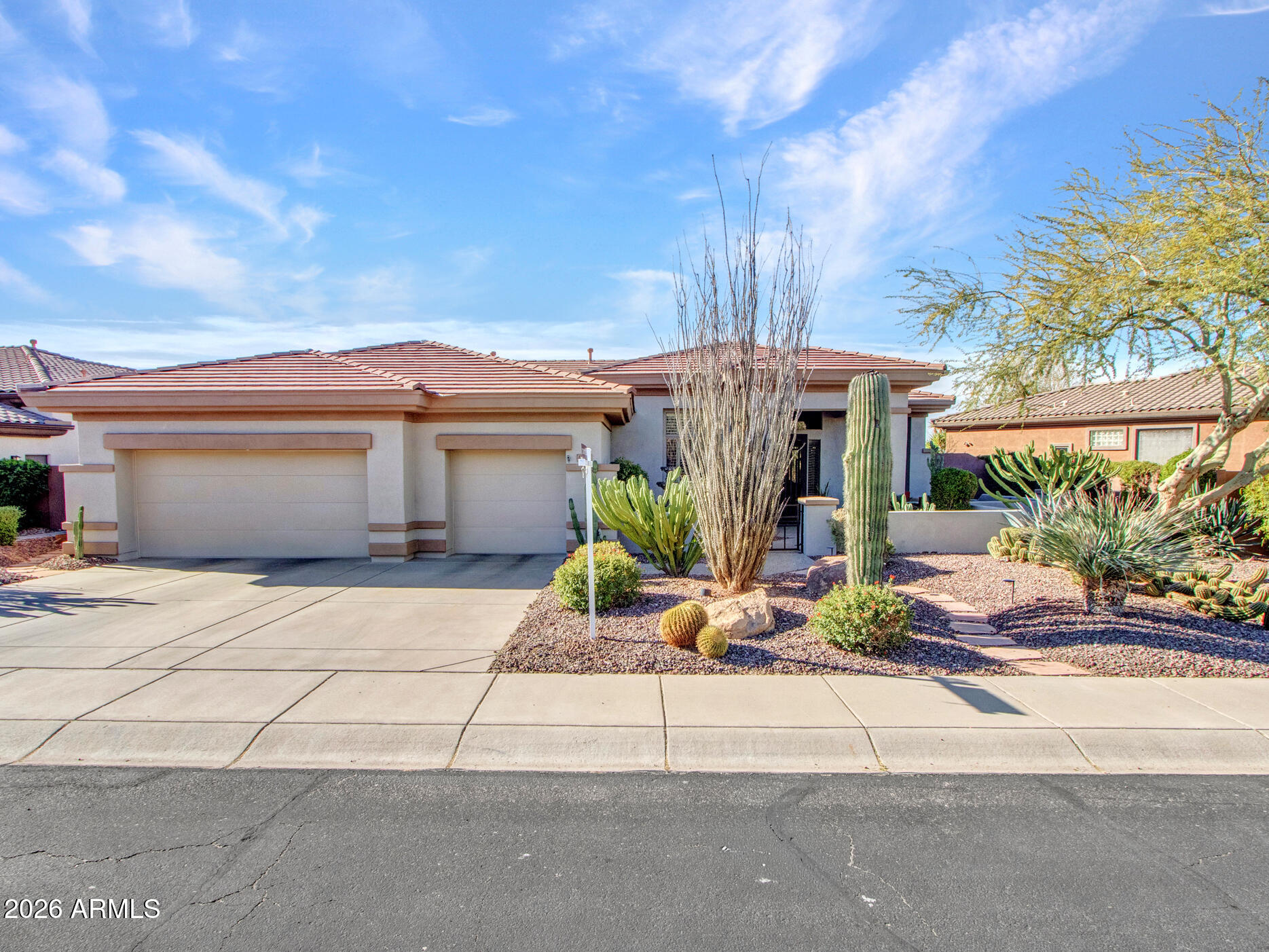 42047 North Moss Springs Road Anthem, AZ 85086 - Photo 3 of 72 a front view of a house with a yard and glass top table and chairs