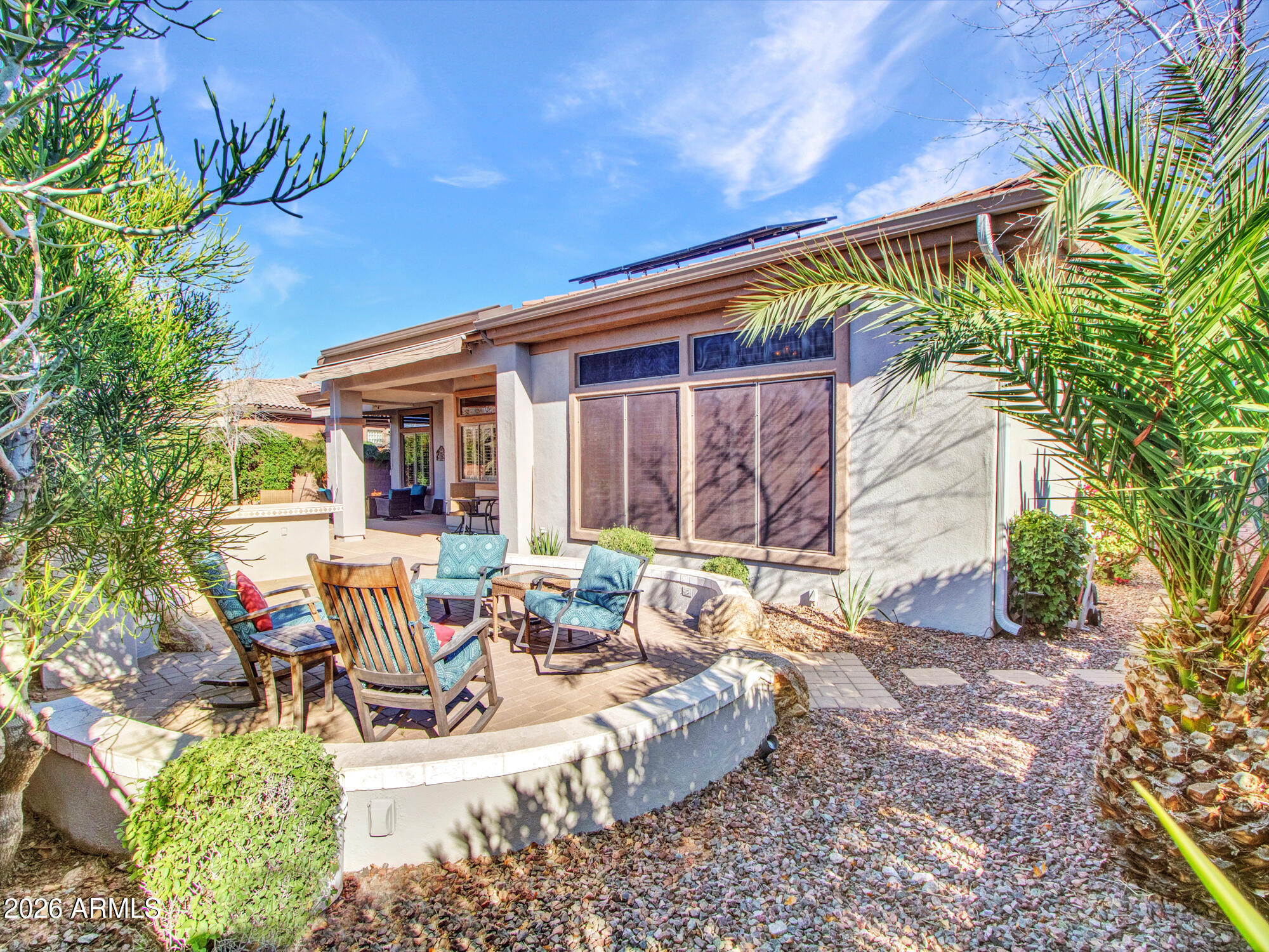 42047 North Moss Springs Road Anthem, AZ 85086 - Photo 49 of 72 a view of a patio with table and chairs potted plants and large tree