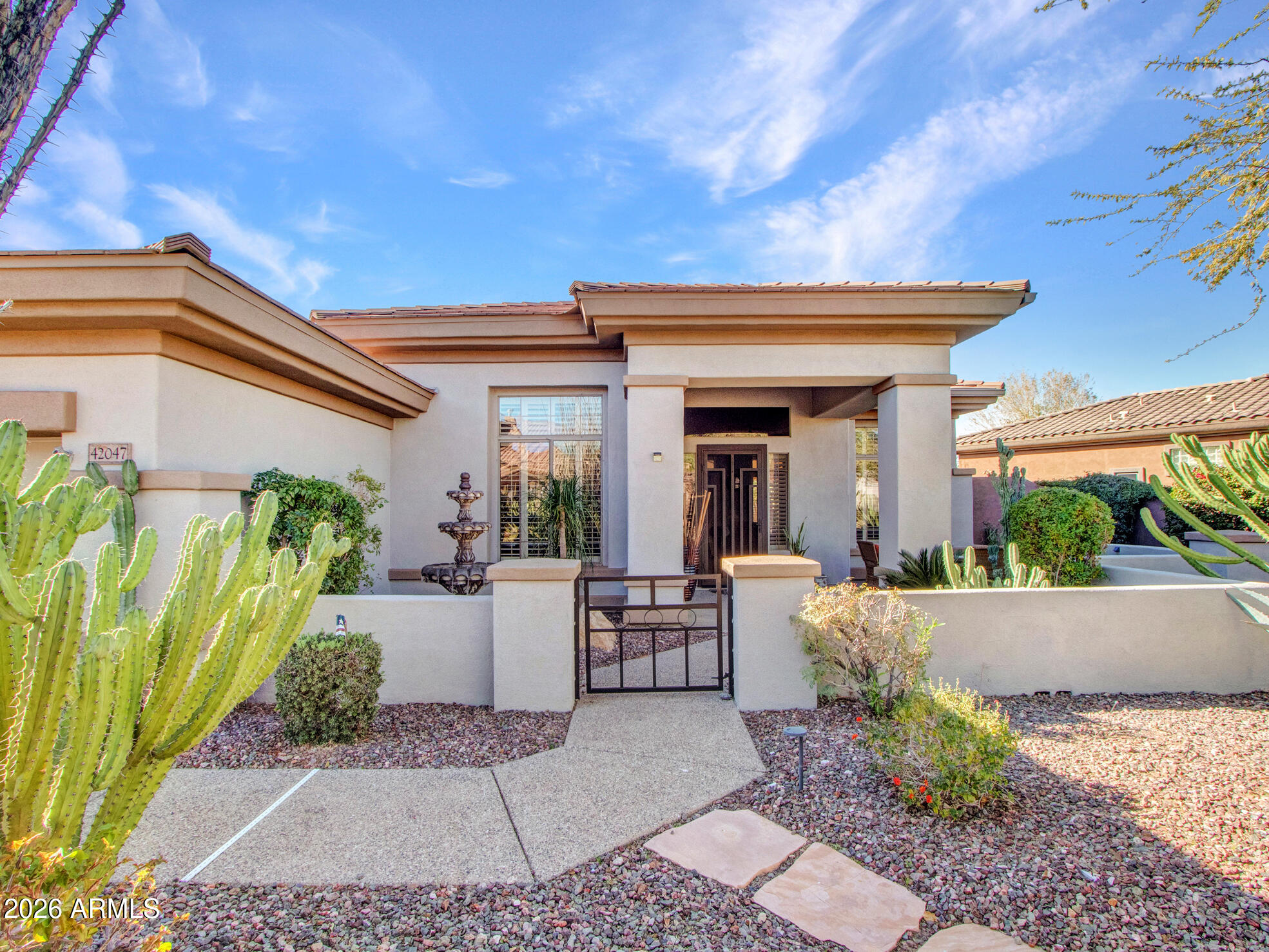 42047 North Moss Springs Road Anthem, AZ 85086 - Photo 4 of 72 a view of a patio with table and chairs potted plants and floor to ceiling window