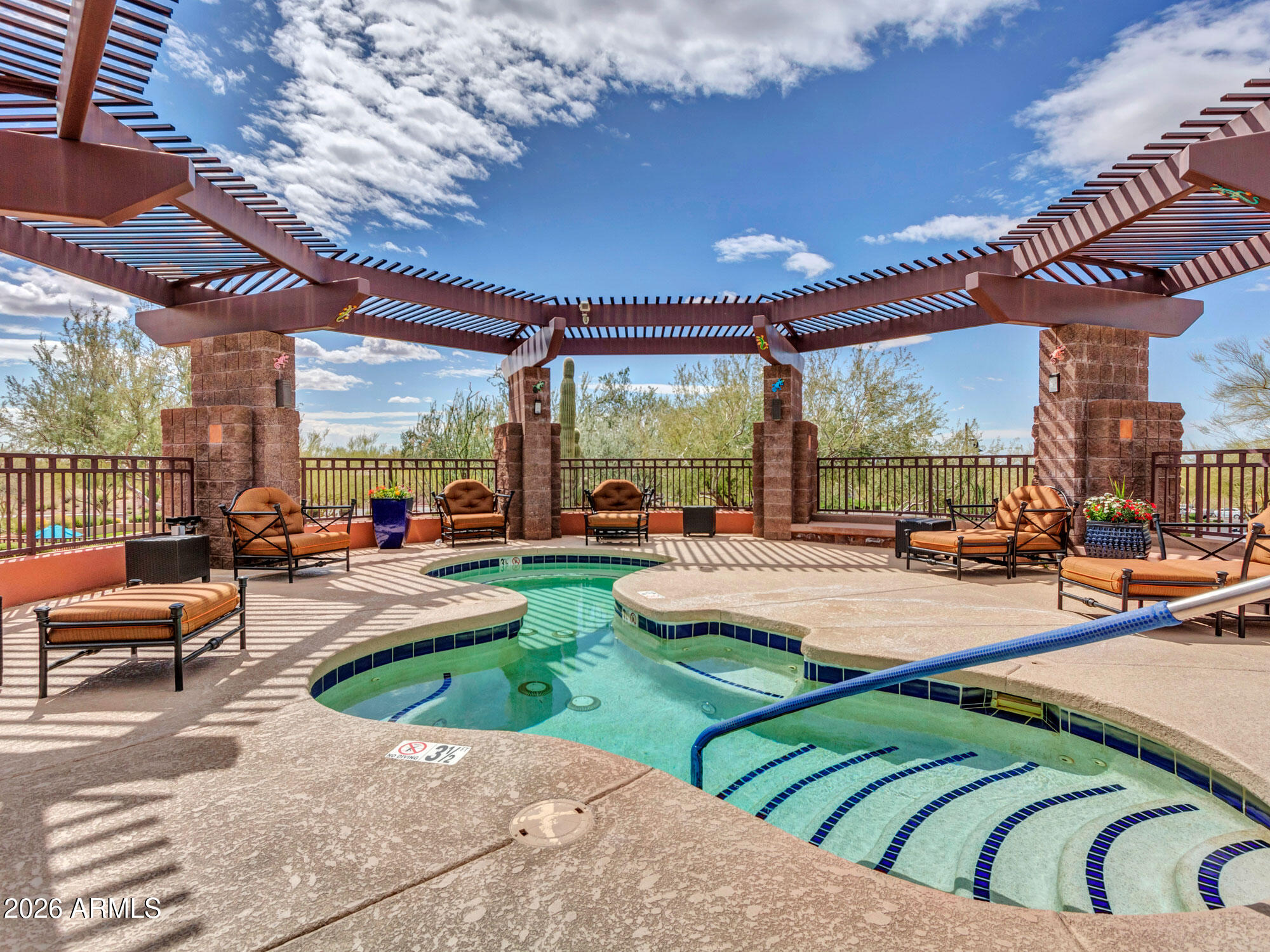 42047 North Moss Springs Road Anthem, AZ 85086 - Photo 65 of 72 a view of a patio with couches and chairs under an umbrella