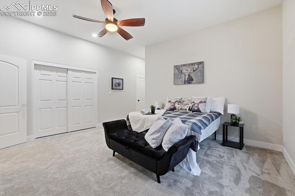 15755 Fool's Gold Lane Colorado Springs, CO 80921 - Photo 28 of 50 a bed room with a bed and a ceiling fan