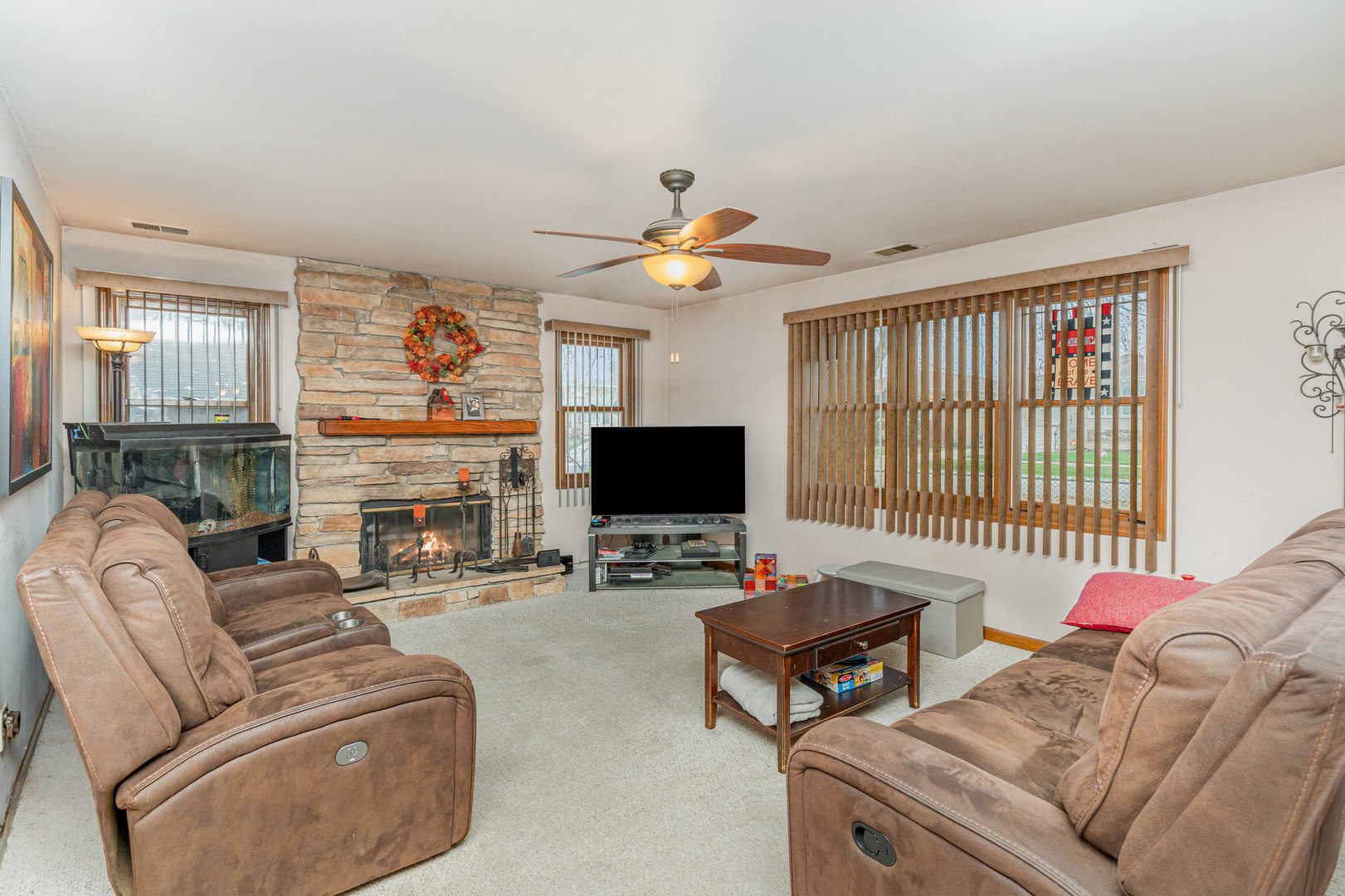 11700 South Springfield Avenue Alsip, IL 60803 - Photo 2 of 21 a living room with furniture a fireplace and a flat screen tv