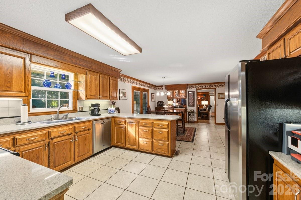 207 Lost Corner Road Morganton, NC 28655 - Photo 18 of 46 a kitchen with stainless steel appliances granite countertop a refrigerator and a stove top oven
