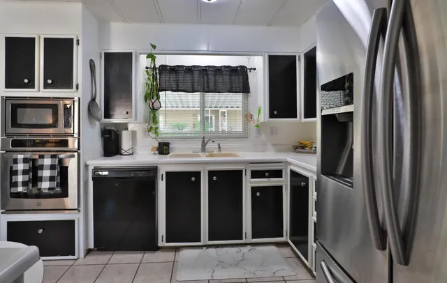 a kitchen with stainless steel appliances a refrigerator and a stove top oven