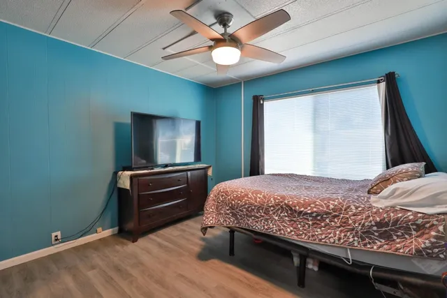 a bedroom with a bed and a chandelier