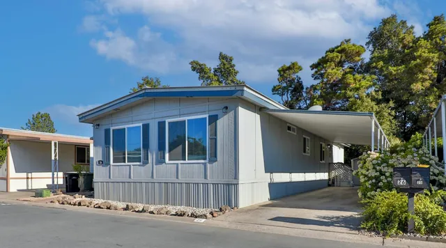 a view of a house with a small yard and plants