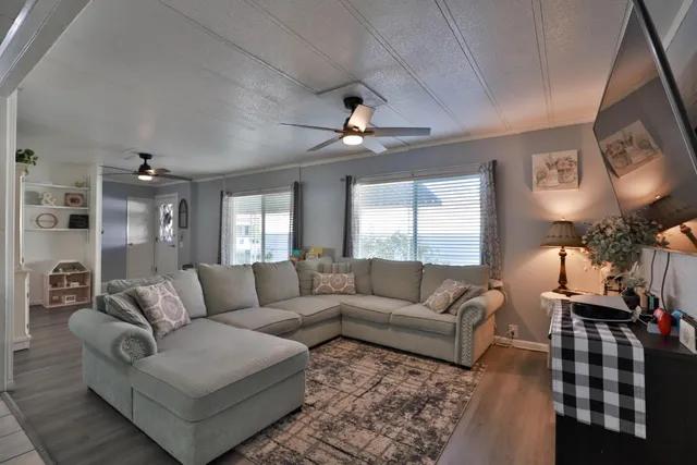 a living room with furniture and a chandelier