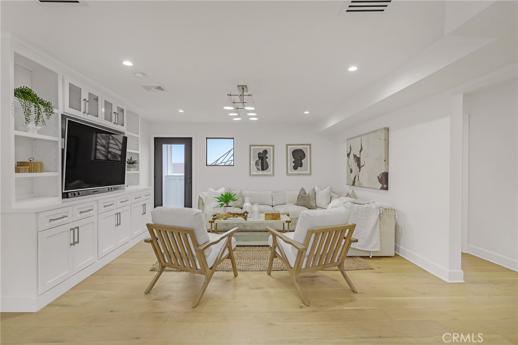 845 4th Street Hermosa Beach, CA 90254 - Photo 11 of 26 a living room with furniture and a flat screen tv