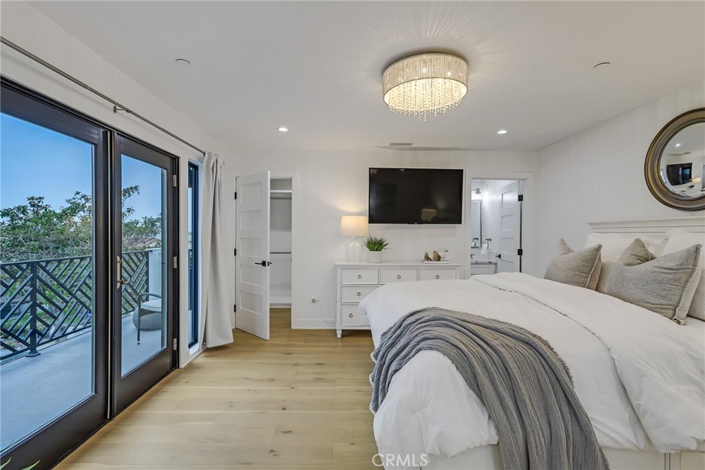 845 4th Street Hermosa Beach, CA 90254 - Photo 13 of 26 a spacious bedroom with a bed and a flat screen tv