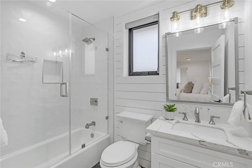 845 4th Street Hermosa Beach, CA 90254 - Photo 16 of 26 a bathroom with a granite countertop sink toilet a shower and a mirror