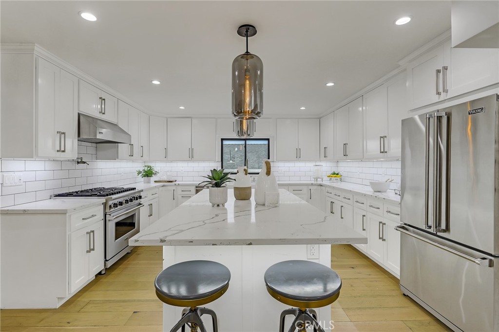845 4th Street Hermosa Beach, CA 90254 - Photo 7 of 26 a kitchen with stainless steel appliances granite countertop a sink stove and refrigerator