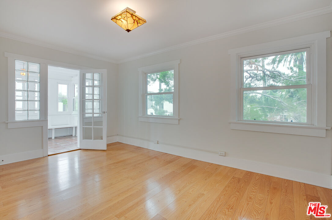 426 Rialto Avenue, Unit B Venice, CA 90291 - Photo 8 of 17 a view of an empty room with a window and wooden floor