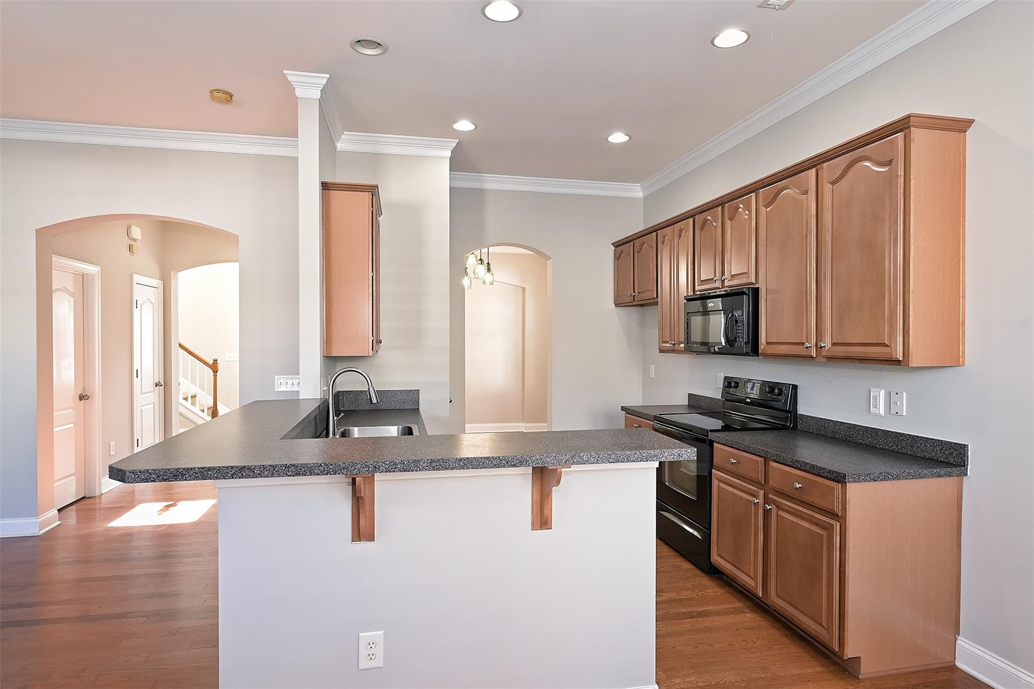 10725 Serape Road Charlotte, NC 28277 - Photo 12 of 30 a kitchen with stainless steel appliances granite countertop a sink a stove and a refrigerator