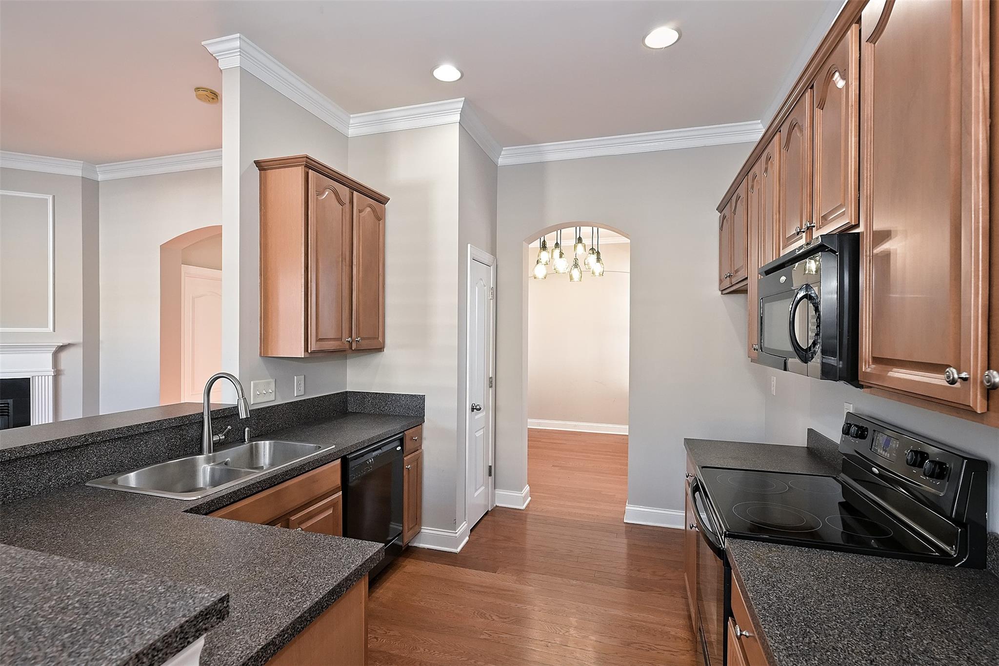10725 Serape Road Charlotte, NC 28277 - Photo 14 of 30 a kitchen with stainless steel appliances granite countertop a sink stove and refrigerator