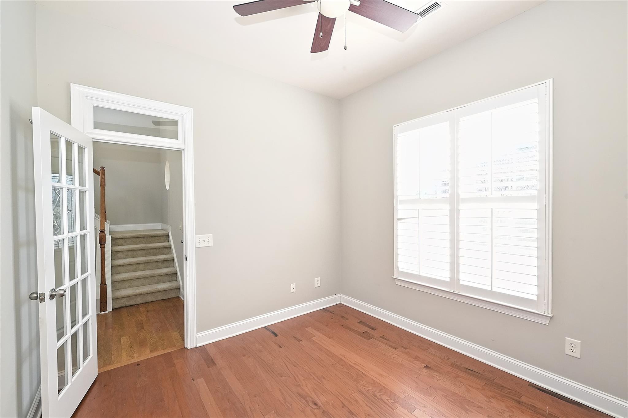 10725 Serape Road Charlotte, NC 28277 - Photo 3 of 30 an empty room with wooden floor cabinet and windows