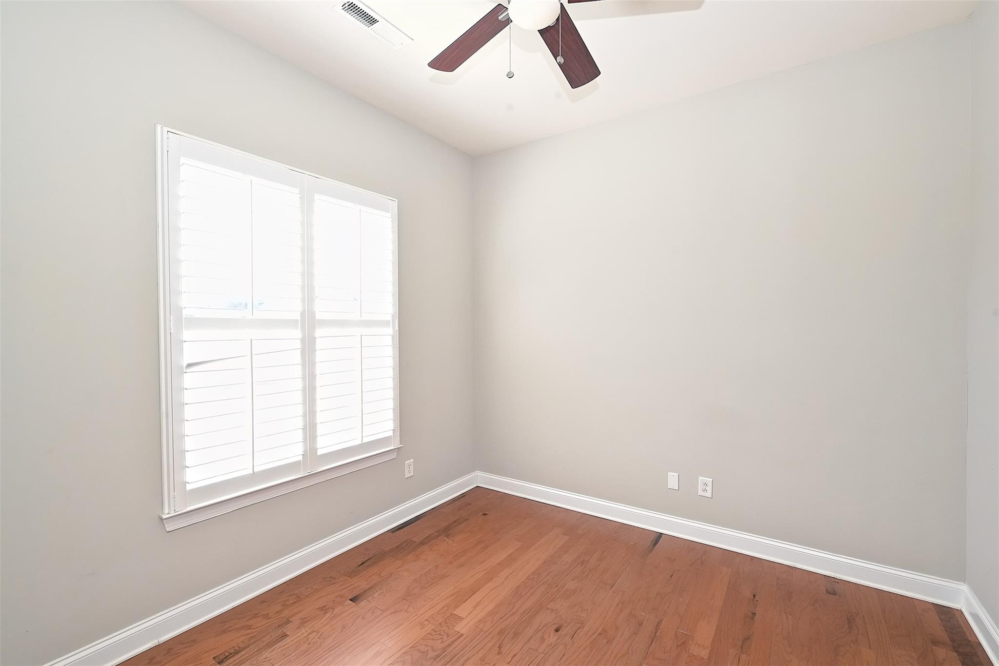 10725 Serape Road Charlotte, NC 28277 - Photo 4 of 30 an empty room with a window and ceiling fan