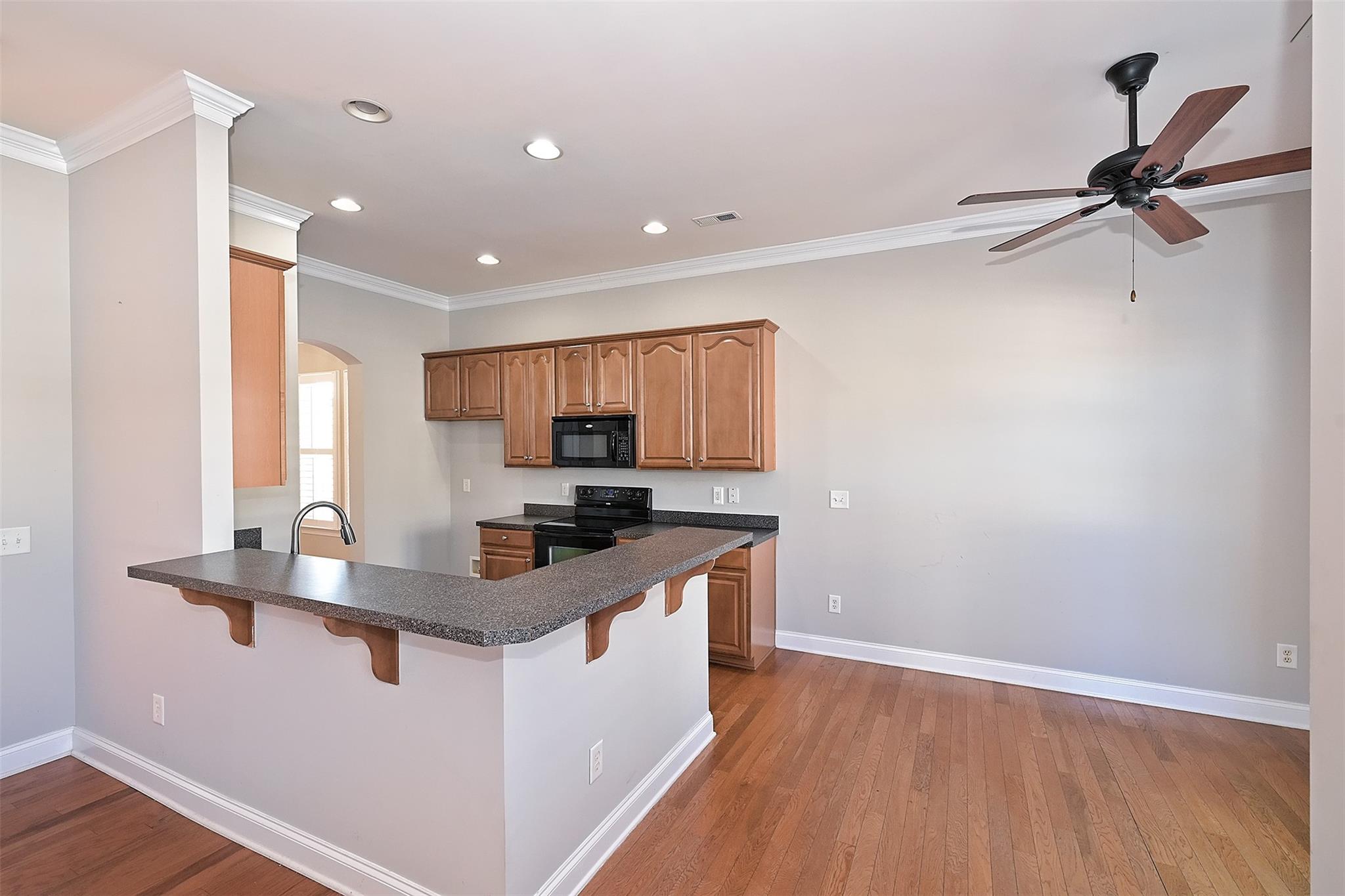 10725 Serape Road Charlotte, NC 28277 - Photo 10 of 30 a kitchen with stainless steel appliances granite countertop a sink stove and refrigerator