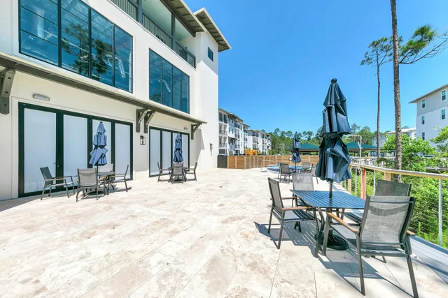a view of a dinning tables and chairs in patio of a house