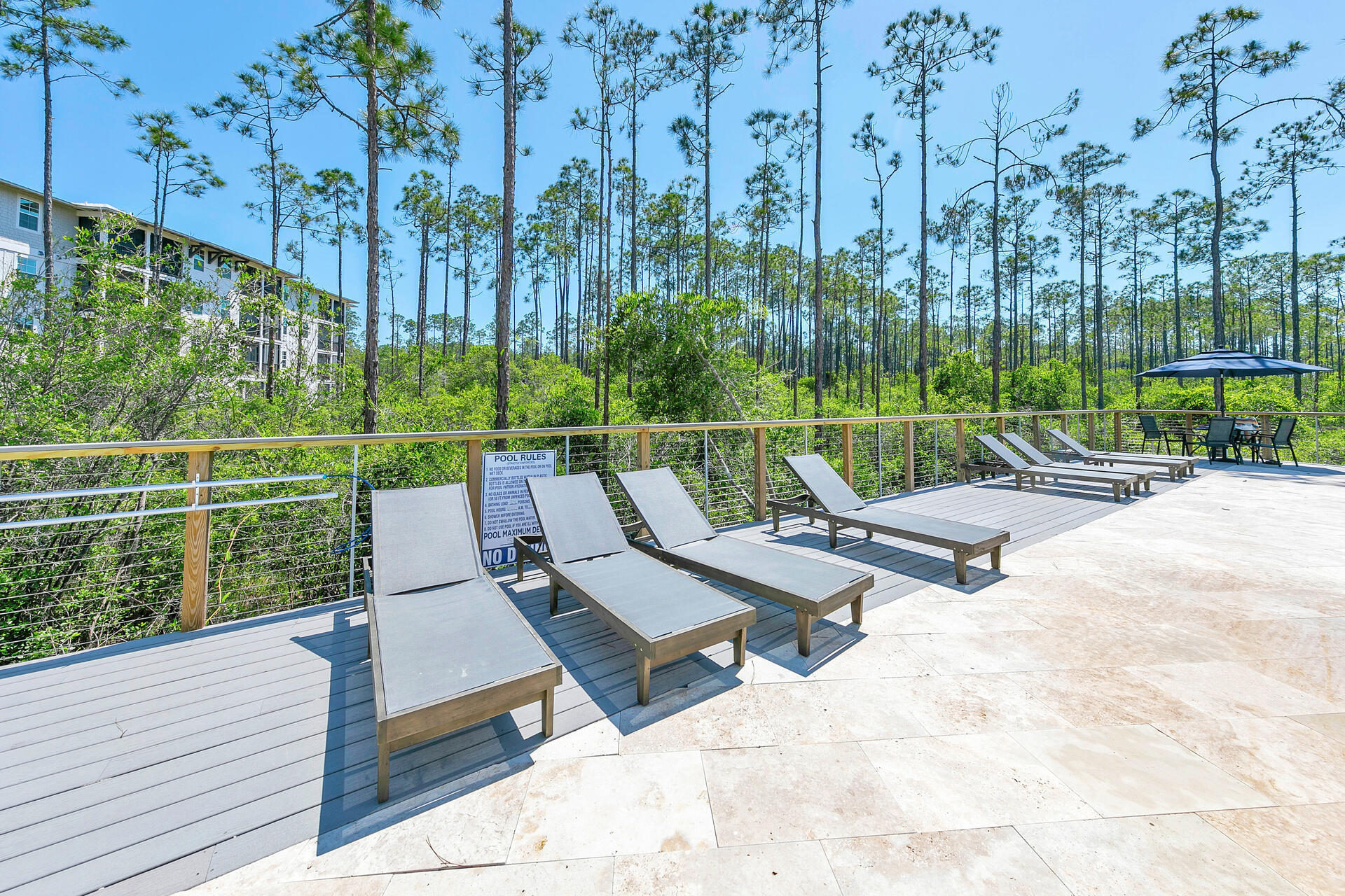179 South County Highway 393, Unit 415 Santa Rosa Beach, FL 32459 - Photo 18 of 26 a view of a park with couches and wooden floor