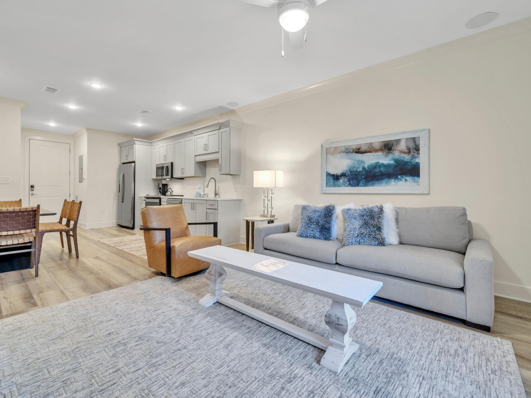 179 South County Highway 393, Unit 415 Santa Rosa Beach, FL 32459 - Photo 7 of 26 a living room with furniture and a dining table with kitchen view