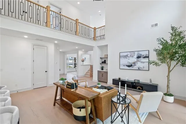 a living room with furniture a table and a potted plant