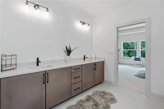 a bathroom with a double vanity sink and a mirror